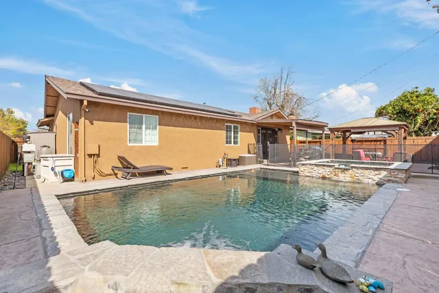 a swimming pool with outdoor seating and yard