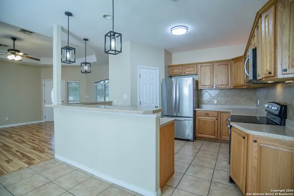 a kitchen with stainless steel appliances granite countertop a sink and refrigerator