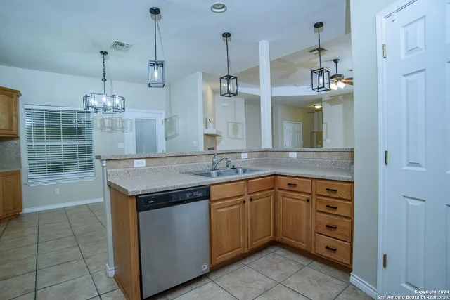 a bathroom with a granite countertop sink a large mirror and a shower