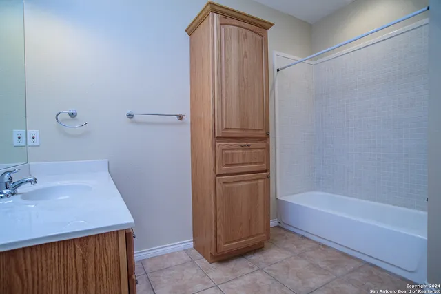 a bathroom with a bathtub and a sink