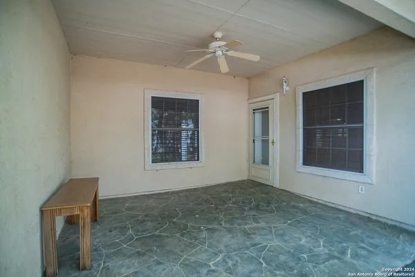 an empty room with windows and closet