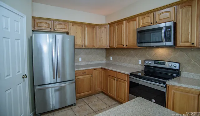 a kitchen with a refrigerator stove and microwave