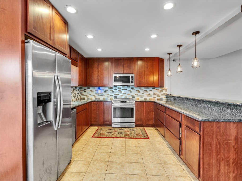 2703 Shady Lane Webster, TX 77598 - Photo 5 of 25 Kitchen with beautiful cabinetry and stainless steel appliances