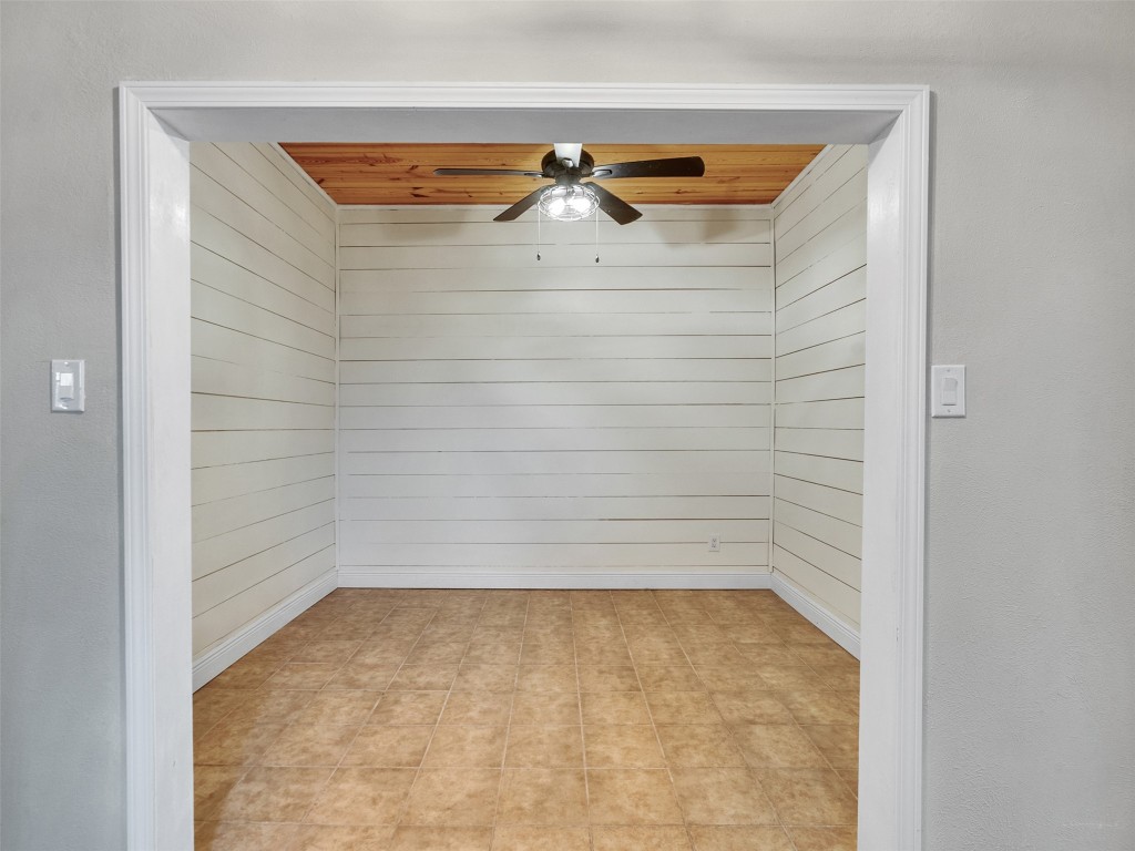 2703 Shady Lane Webster, TX 77598 - Photo 9 of 25 Cozy home office with stylish shiplap walls and a ceiling fan for comfort and productivity