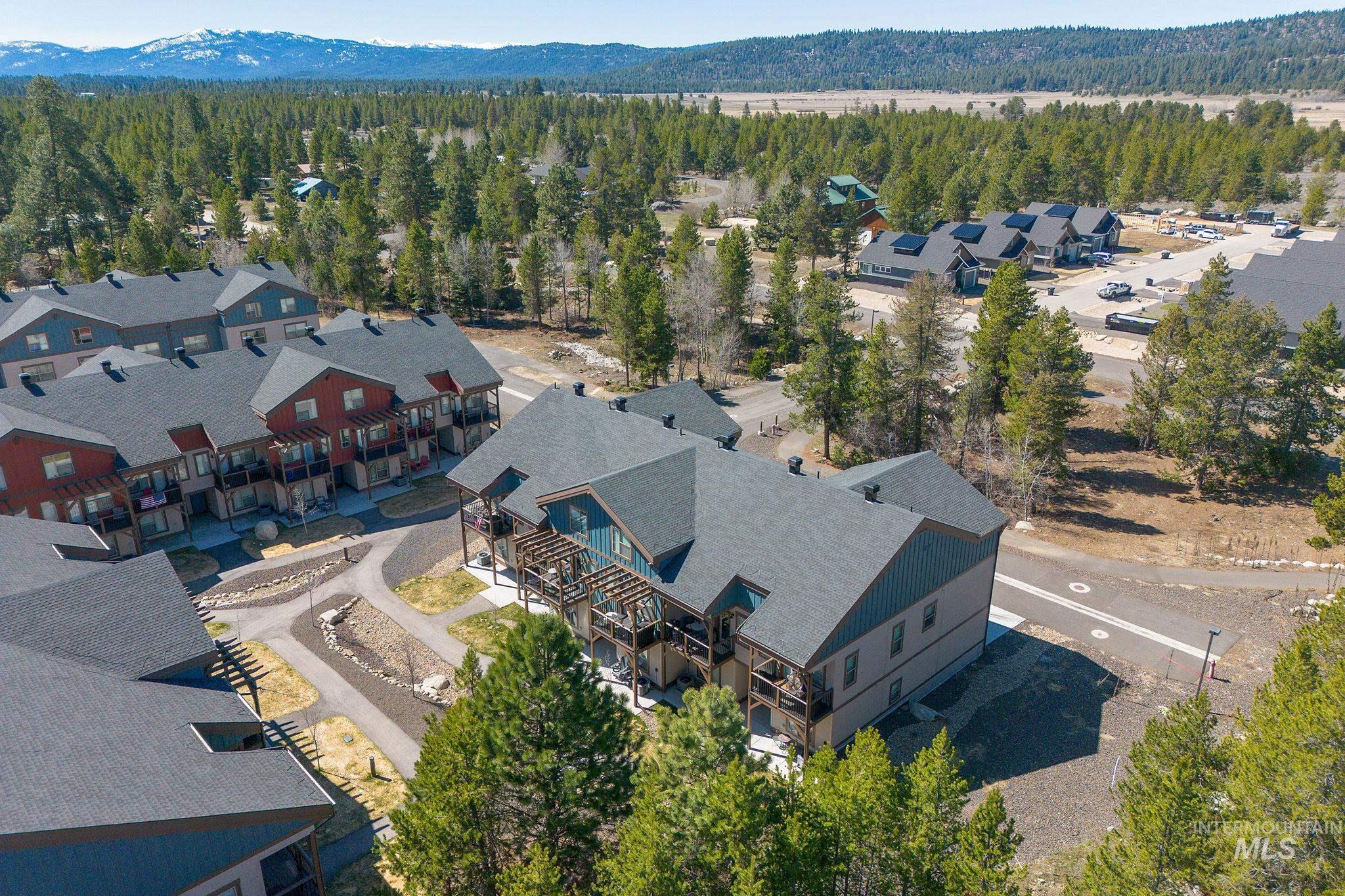 311 Broken Ridge Way McCall, ID 83638 - Photo 34 of 44 Contemporary multi-story buildings featuring dark shingle roofs, balconies, and exterior siding in various earth tones