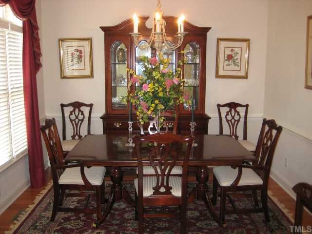 7408 Fontana Ridge Lane Raleigh, NC 27613 - Photo 6 of 12 a view of a dining room with furniture and chandelier
