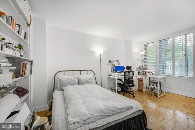 a bed room with a bed window and a chair