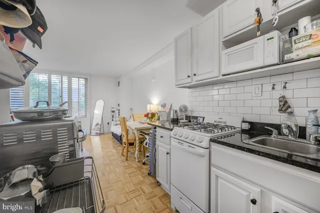 a kitchen with a sink stove and cabinets