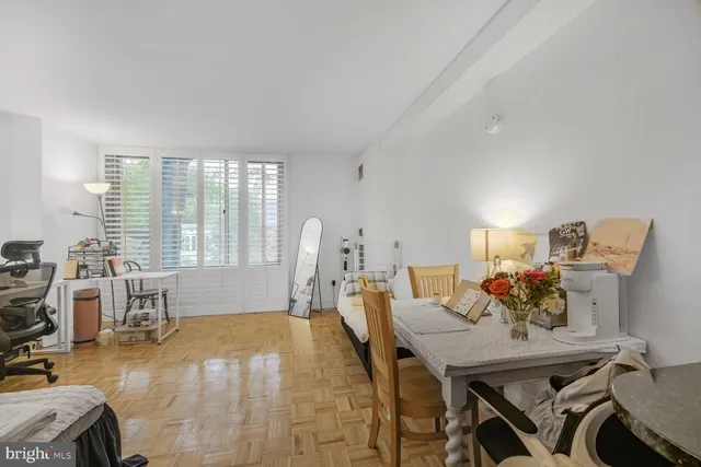 a view of a dining room with furniture and a large window