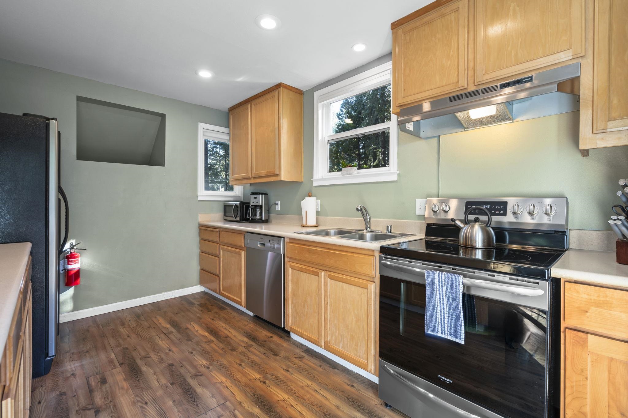 6415 Flicker Avenue Homewood, CA 96141 - Photo 15 of 28 a kitchen with stainless steel appliances granite countertop a sink stove and refrigerator