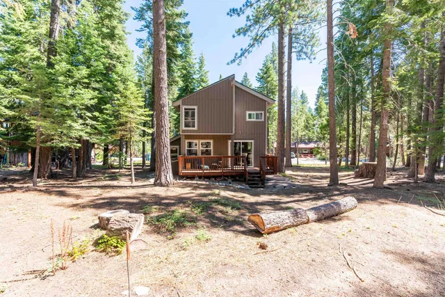a view of a house with trees in the background
