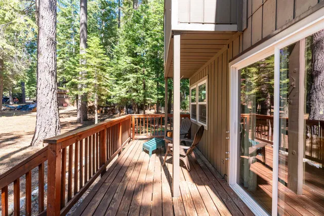 a view of balcony with wooden floor and fence