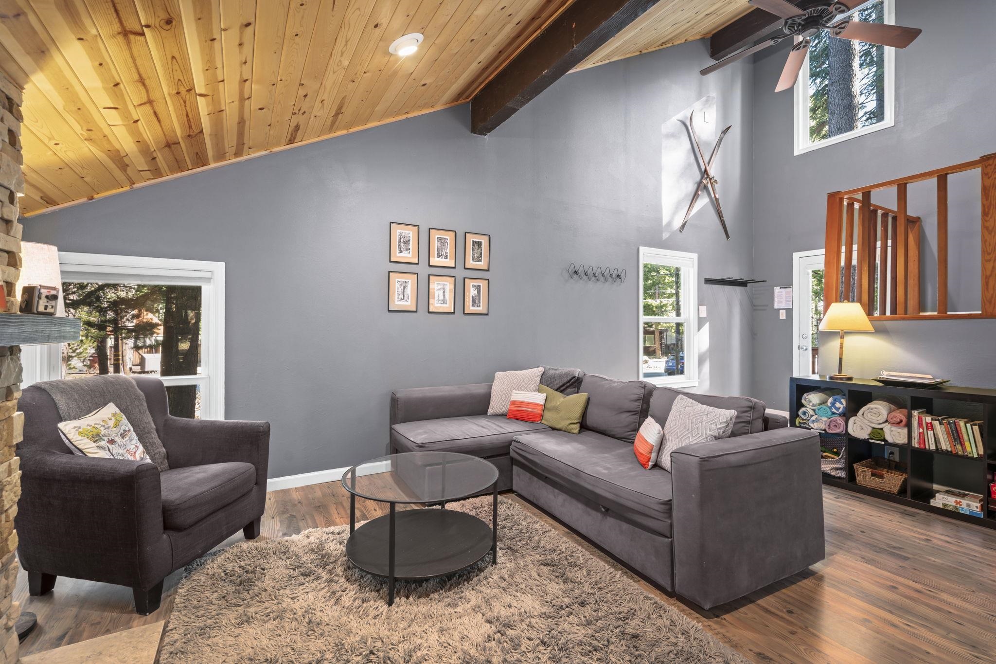 6415 Flicker Avenue Homewood, CA 96141 - Photo 3 of 28 a living room with furniture a bookshelf and a window