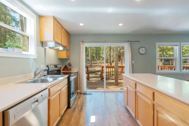 a kitchen with a sink stove and cabinets