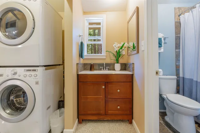 a bathroom with a sink a mirror and a toilet