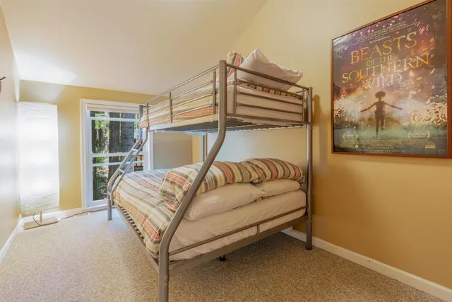 a bedroom with a bed and a painting on the wall