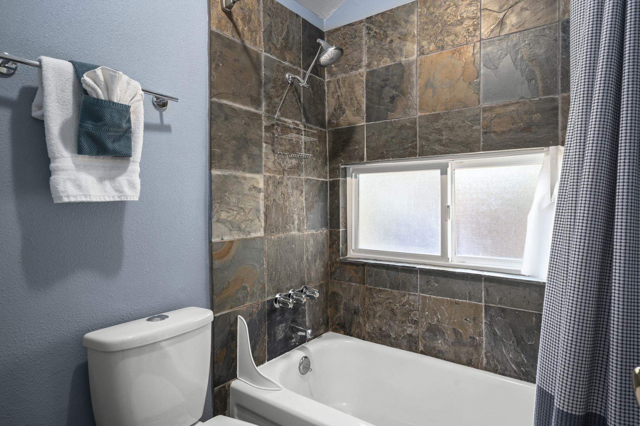 6415 Flicker Avenue Homewood, CA 96141 - Photo 10 of 28 a bath tub sitting next to a white toilet and a shower