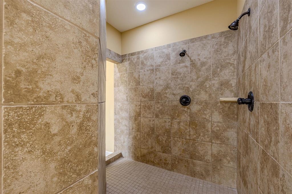 5380 Scarlet Ridge Drive Arlington, TN 38002 - Photo 18 of 35 Walk-in shower with full-height tile surround, dual shower heads, and an integrated shower bench