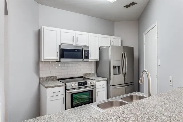 a kitchen with a refrigerator sink and microwave