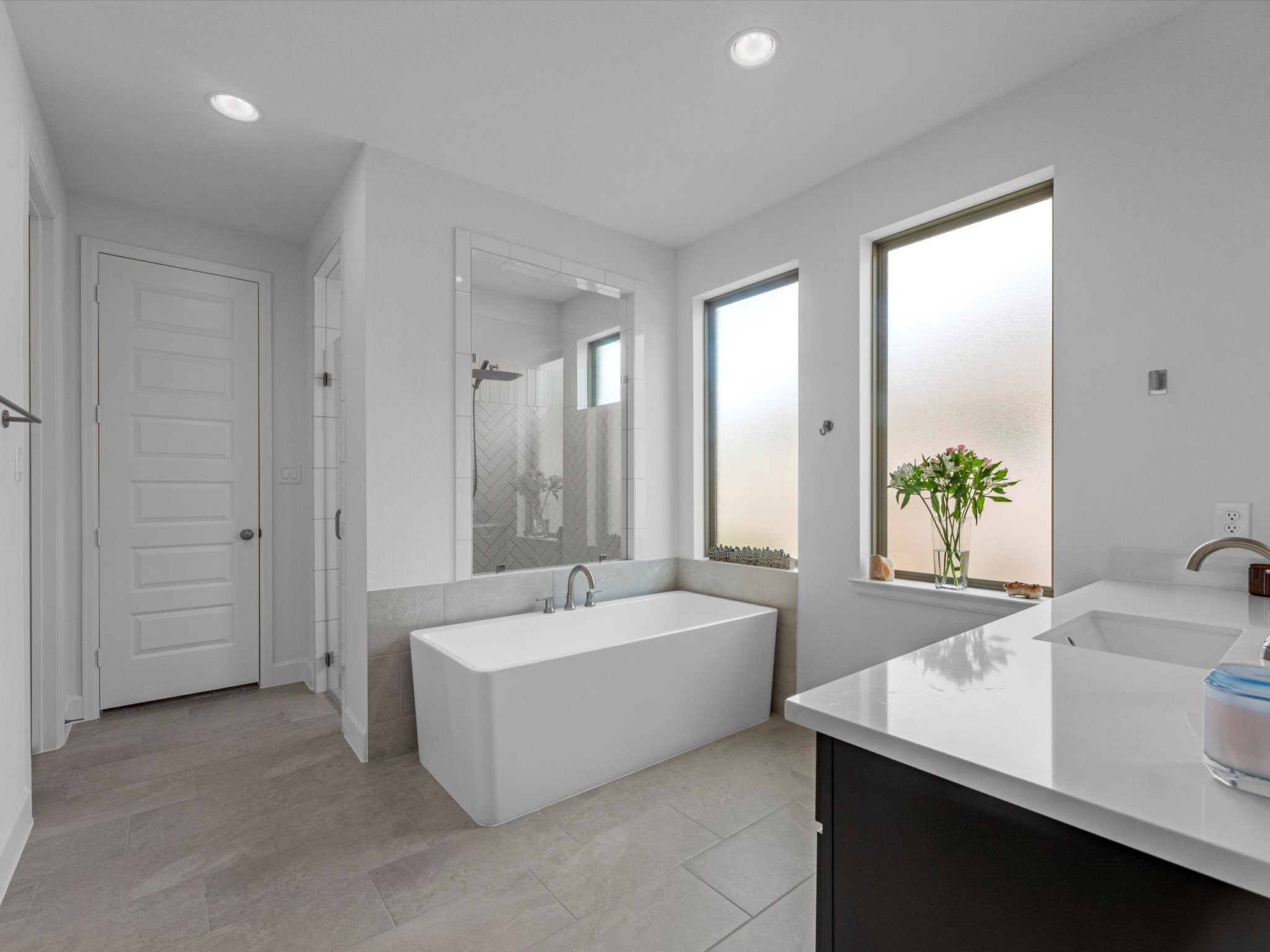 18714 Pistachio Way Manvel, TX 77578 - Photo 20 of 48 The spa-inspired primary bath is designed for everyday luxury, featuring abundant natural light, a freestanding soaking tub, an oversized walk-in shower, and separate his-and-hers walk-in closets.