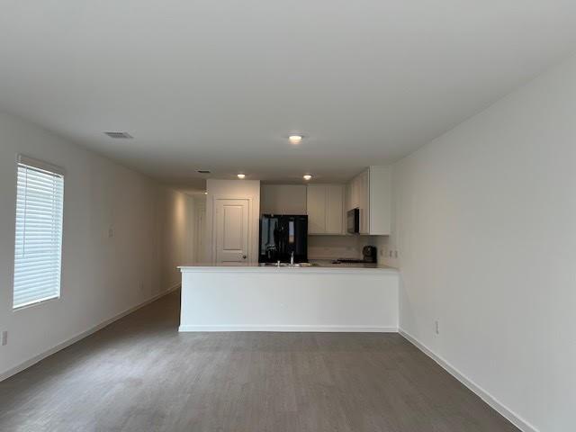 1038 Raintree Road Princeton, TX 75407 - Photo 12 of 36 a view of a kitchen with a sink and a refrigerator