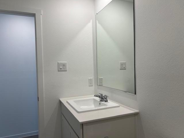 1038 Raintree Road Princeton, TX 75407 - Photo 24 of 36 a bathroom with a sink toilet and mirror