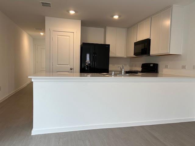 1038 Raintree Road Princeton, TX 75407 - Photo 6 of 36 a kitchen with stainless steel appliances wooden cabinets and a refrigerator