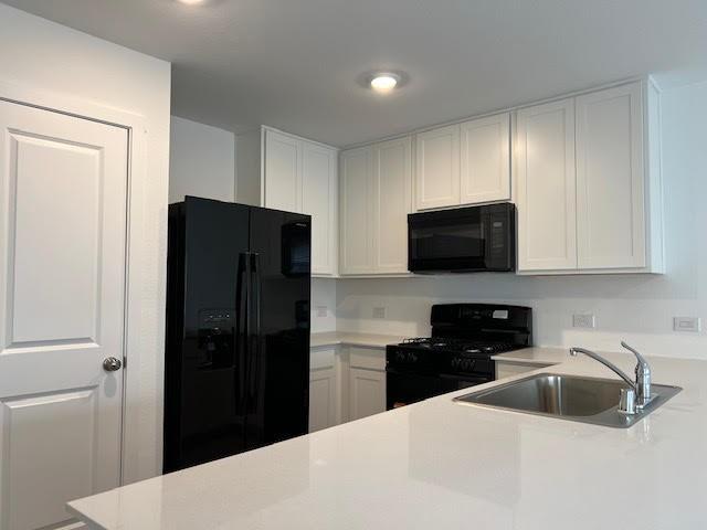 1038 Raintree Road Princeton, TX 75407 - Photo 7 of 36 a kitchen with a refrigerator and a sink