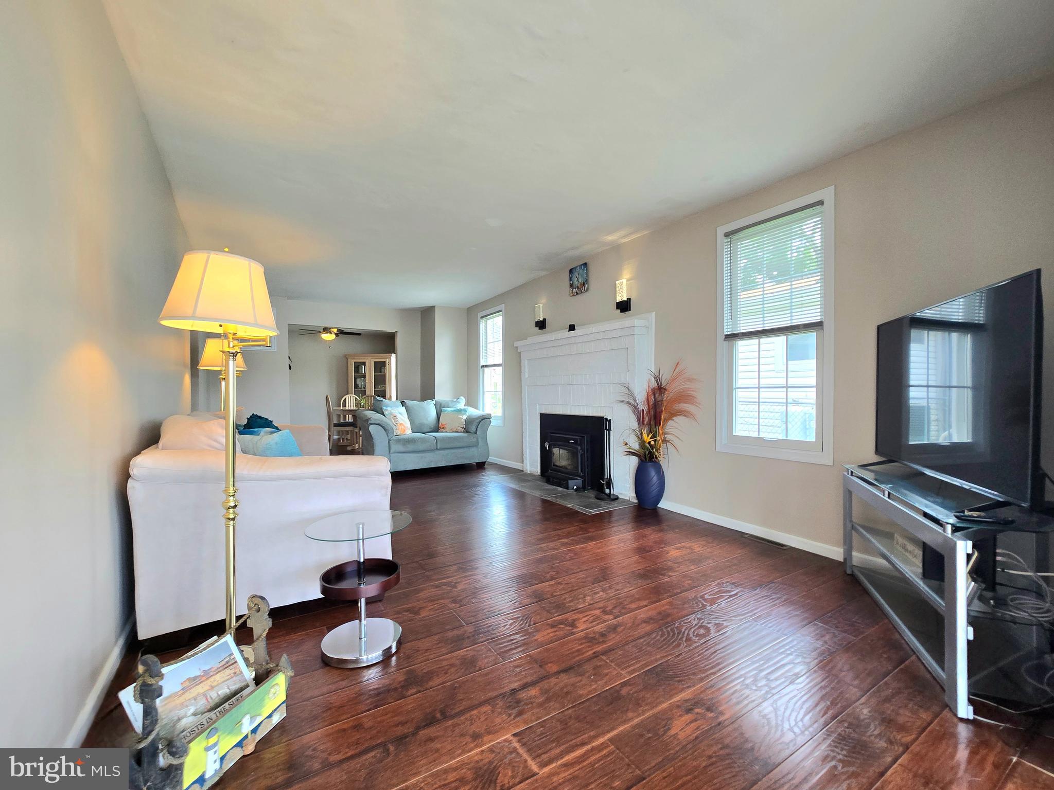 336 Bar Harbor Road Pasadena, MD 21122 - Photo 13 of 82 a living room with furniture a fireplace and a flat screen tv