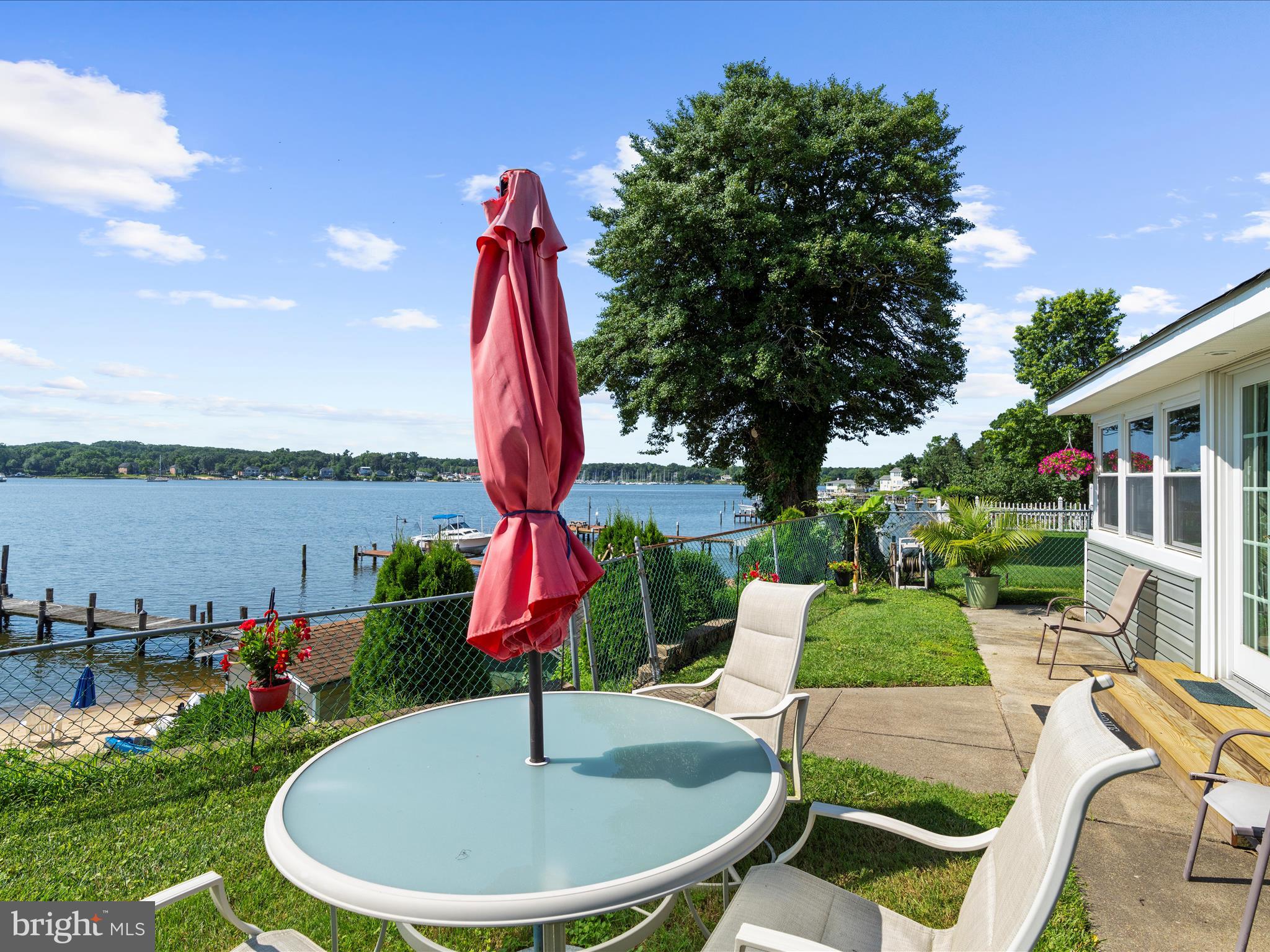 336 Bar Harbor Road Pasadena, MD 21122 - Photo 42 of 82 a view of a backyard with table and chairs potted plants and palm tree