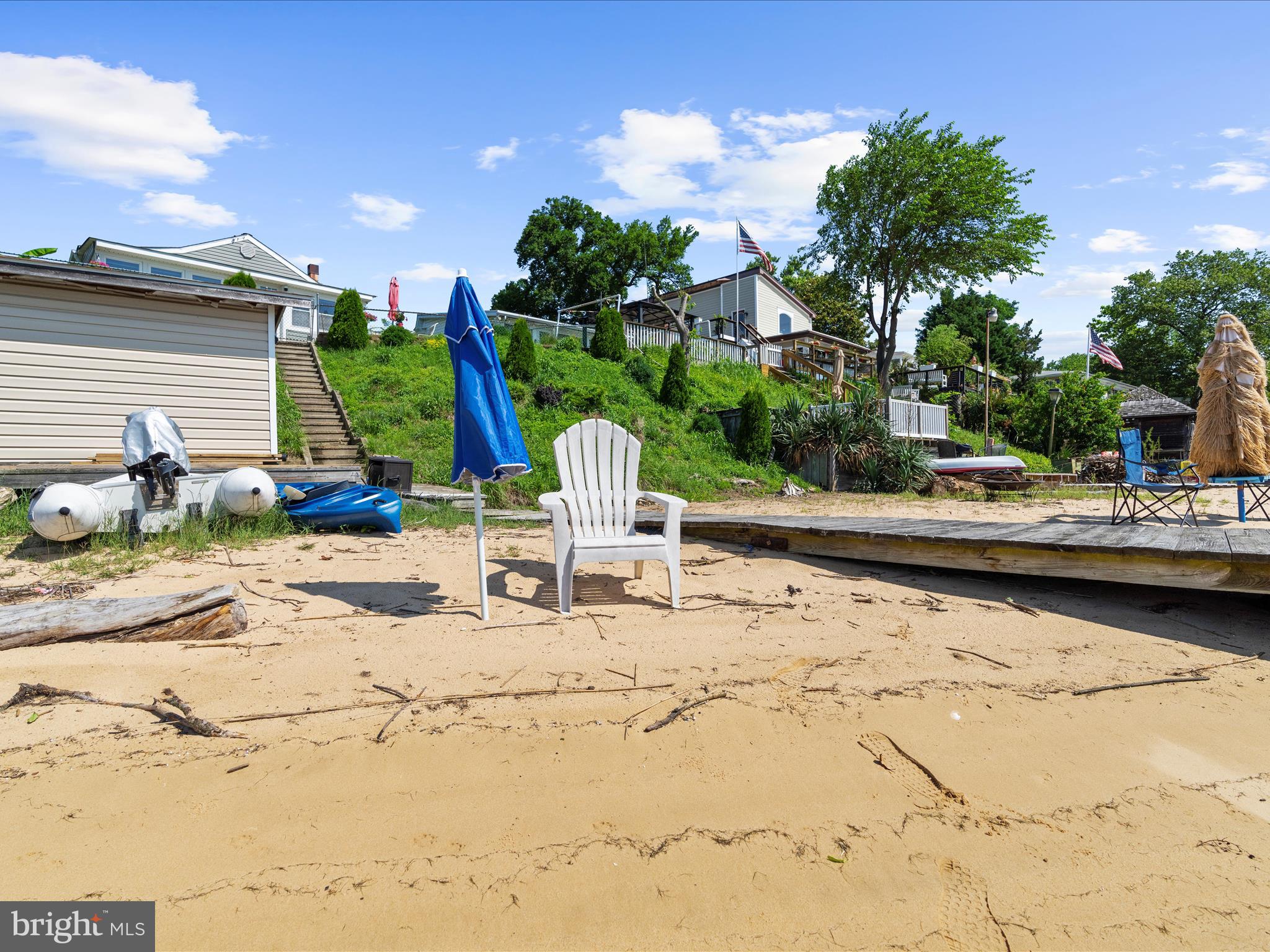 336 Bar Harbor Road Pasadena, MD 21122 - Photo 57 of 82 a view of the ocean with a bench and lawn chairs