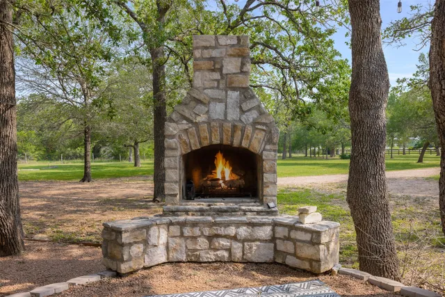 a front view of a house with a garden and tree