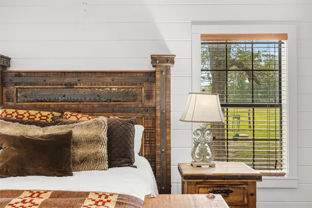 a bathroom with a granite countertop sink a mirror and a bathtub