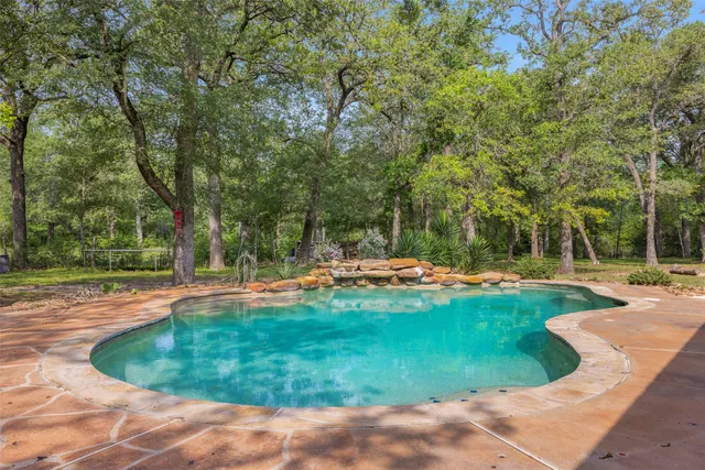 a view of a swimming pool with a patio