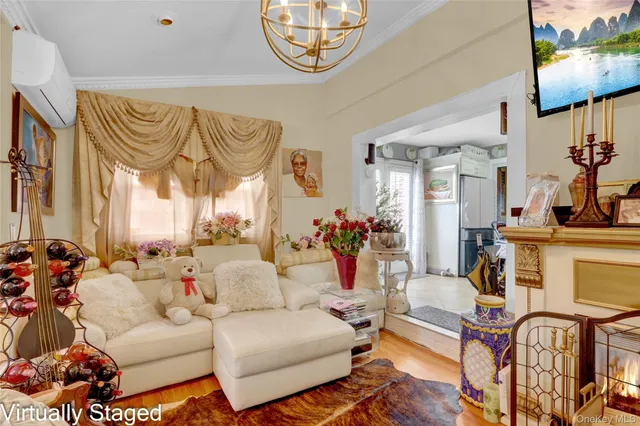 a living room with furniture a fireplace and a chandelier