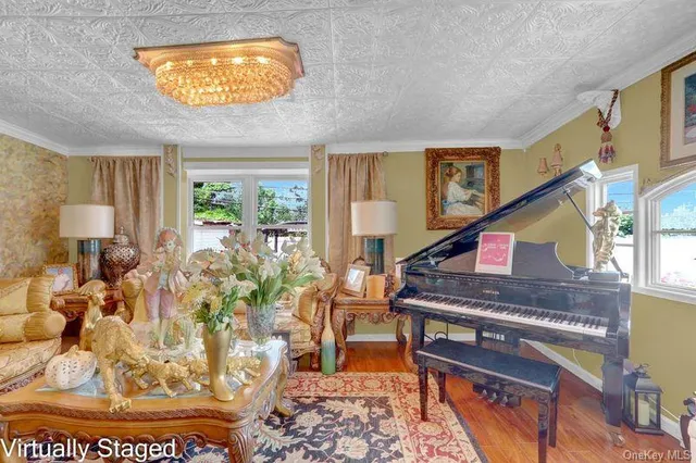 a living room with furniture and a chandelier