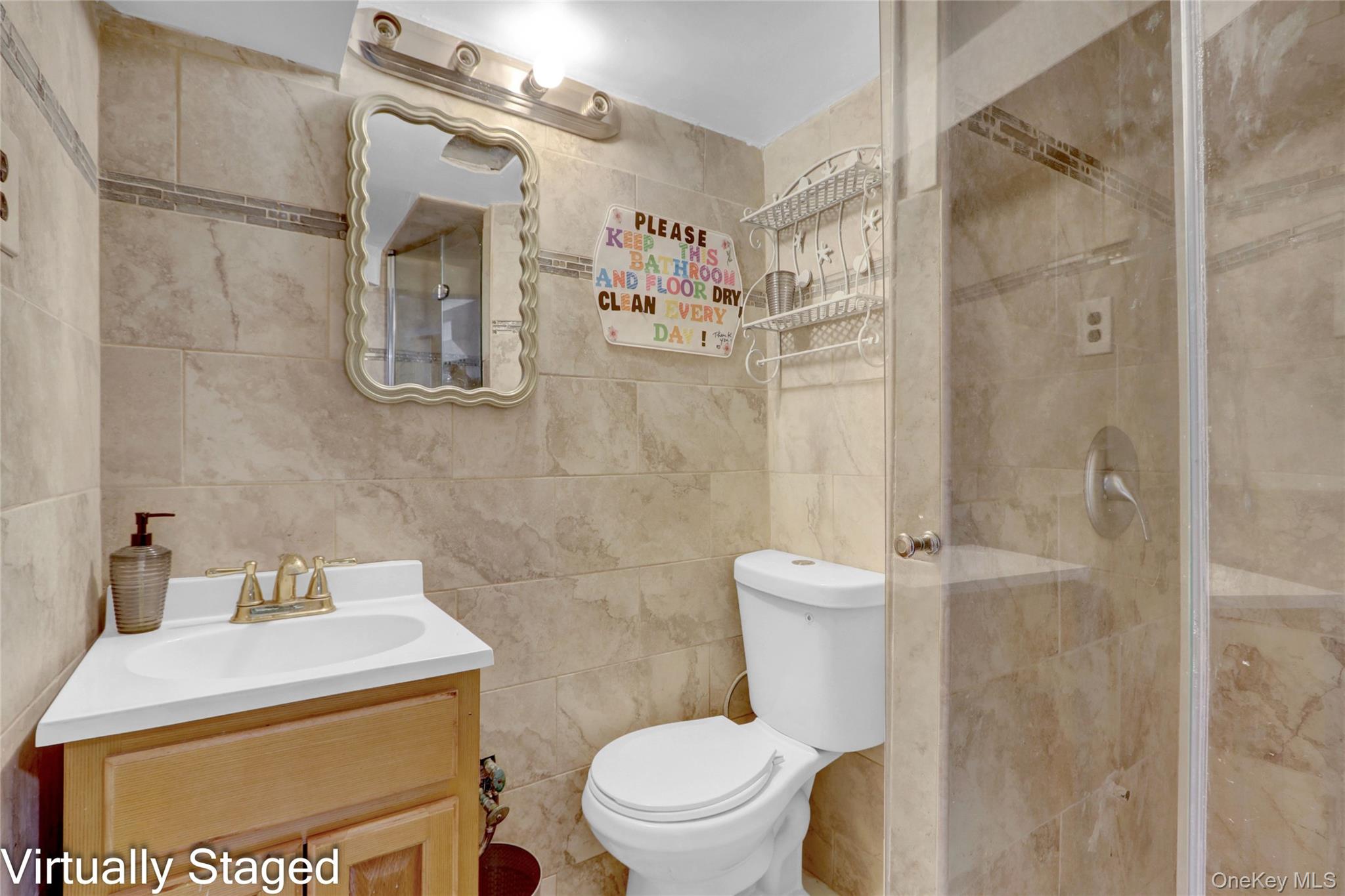 50 Crystal Street Elmont, NY 11003 - Photo 25 of 40 a bathroom with a sink a toilet and shower