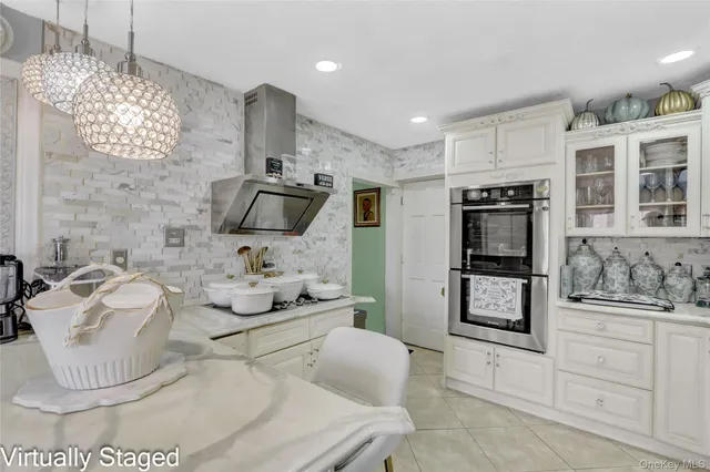 a kitchen with stainless steel appliances kitchen island granite countertop a sink and a refrigerator