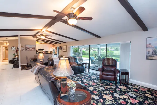 a living room with furniture a rug and a large window