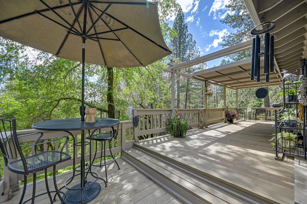 3971 Donner Trail Placerville, CA 95667 - Photo 14 of 78 a view of a patio with table and chairs under an umbrella