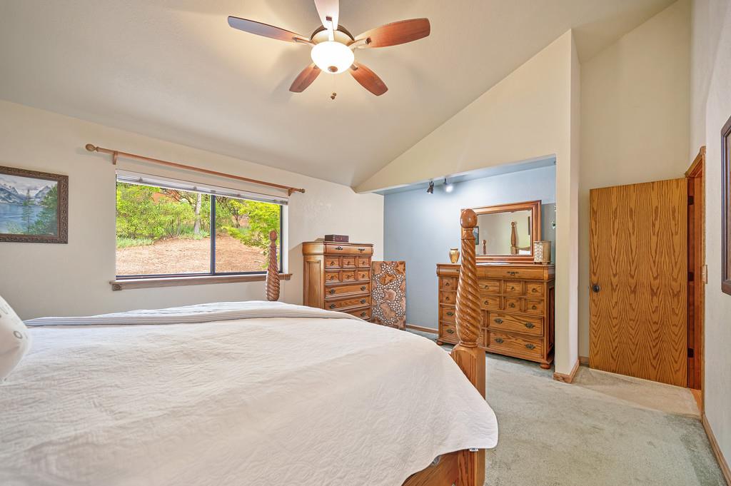 3971 Donner Trail Placerville, CA 95667 - Photo 29 of 78 a bedroom with a large bed and a chandelier