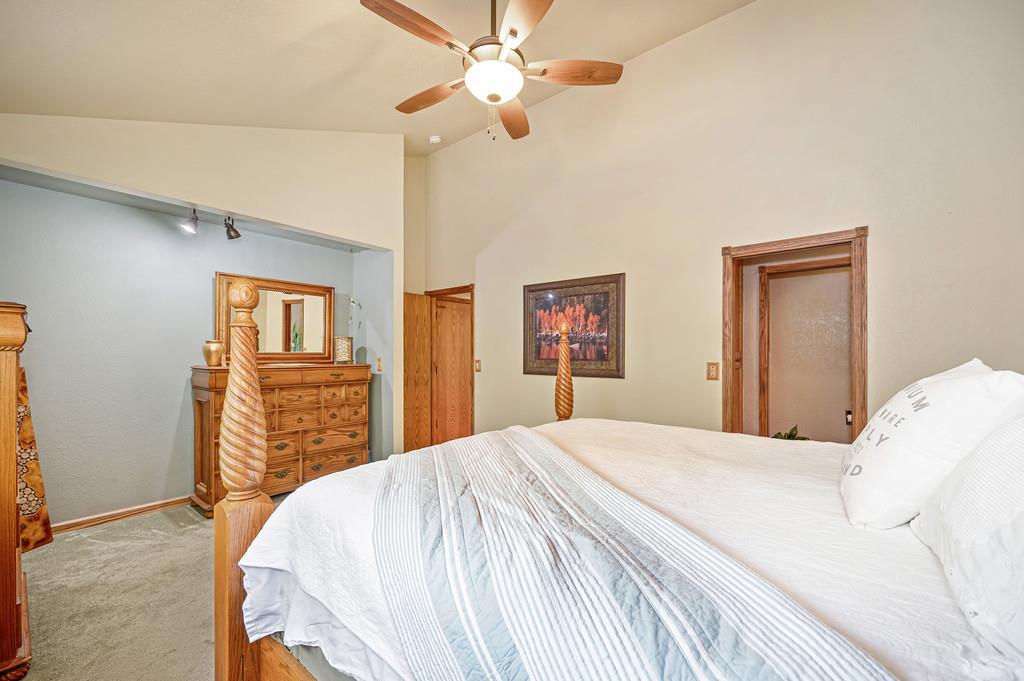 3971 Donner Trail Placerville, CA 95667 - Photo 30 of 78 a bedroom with a bed and a chandelier