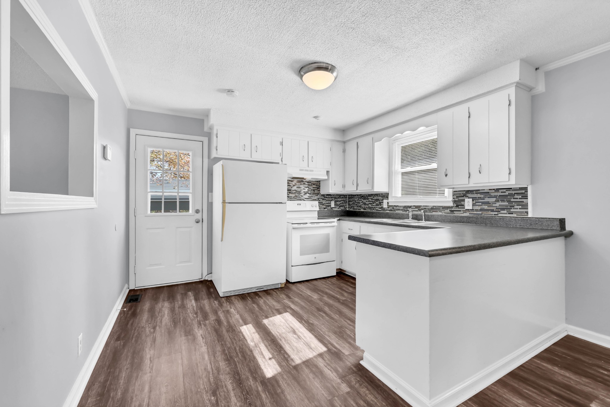 4660 Dover Road Indian Mound, TN 37079 - Photo 10 of 30 a kitchen with granite countertop white cabinets and white appliances