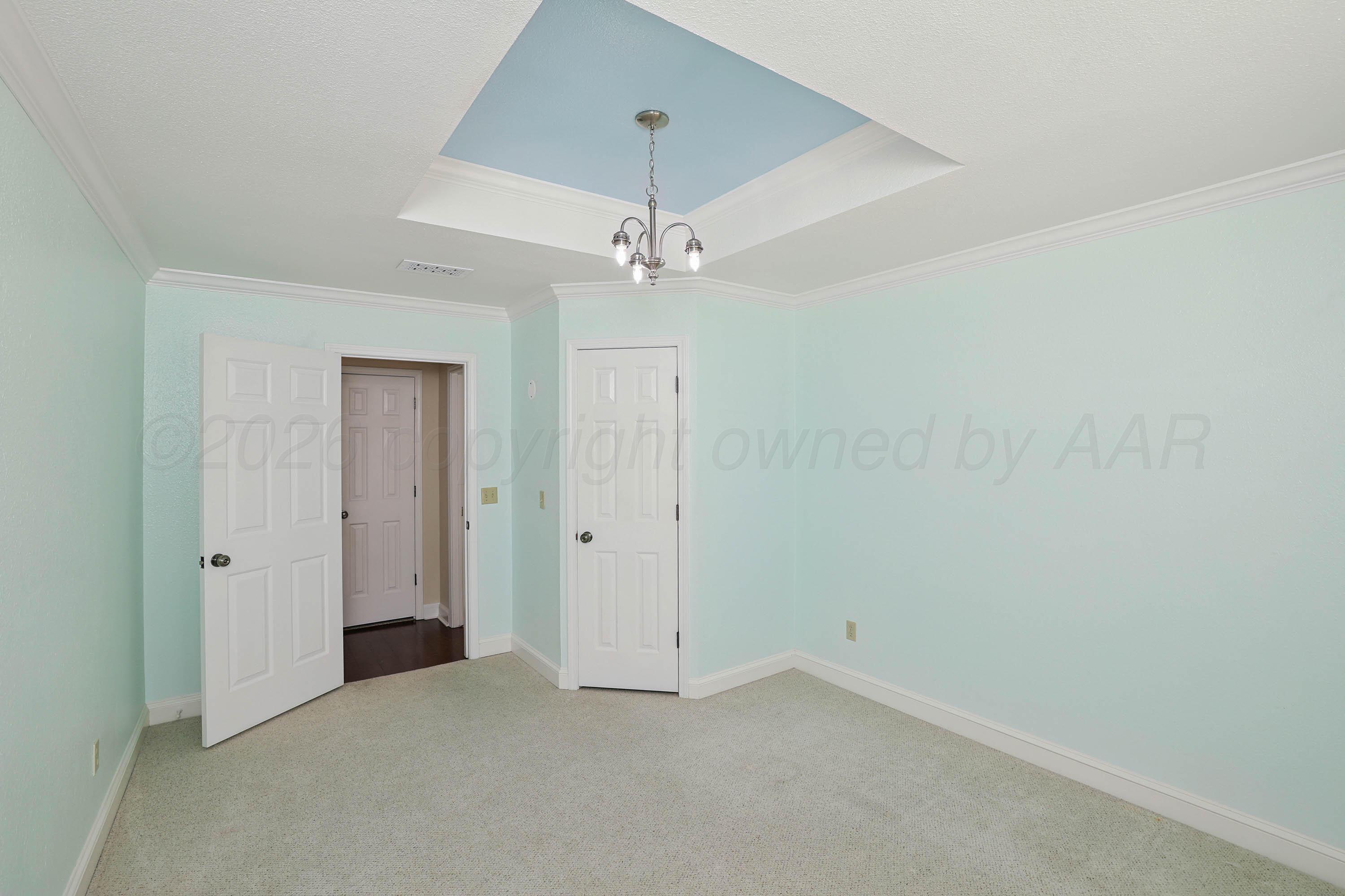 6904 Alpine Lane Amarillo, TX 79109 - Photo 19 of 45 an empty room with a ceiling fan and a window