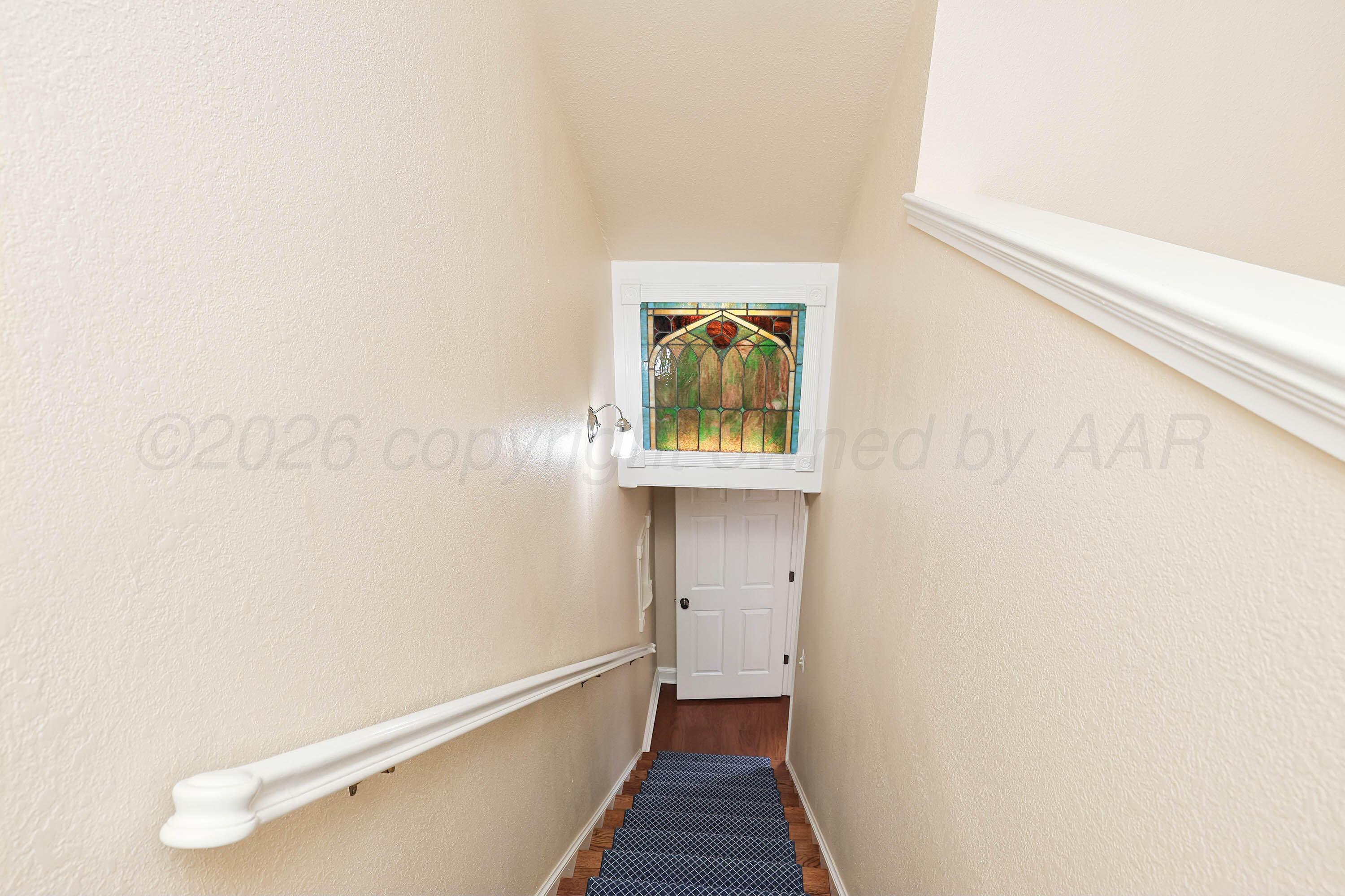 6904 Alpine Lane Amarillo, TX 79109 - Photo 25 of 45 a view of a hallway with wooden floor and a bathroom