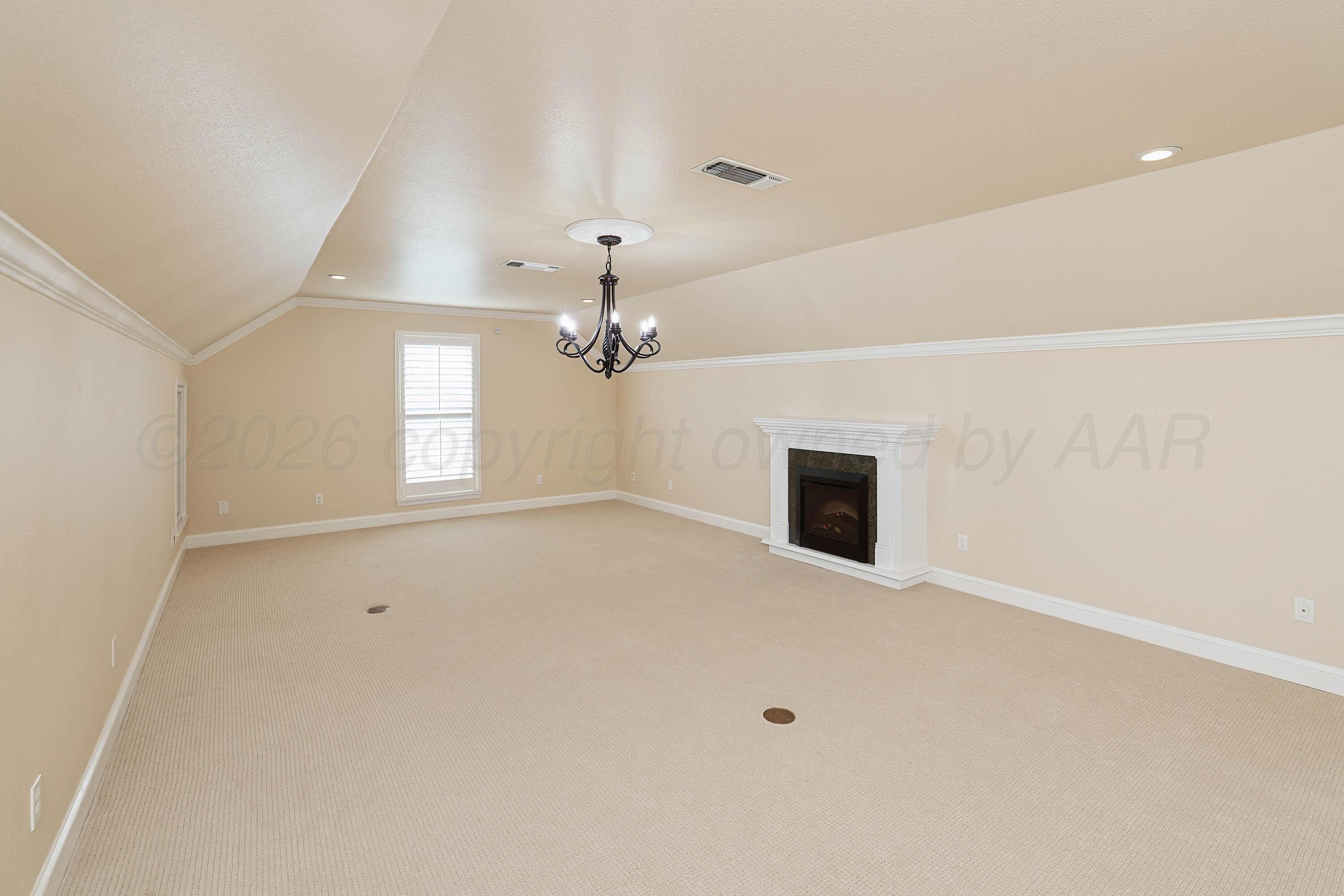 6904 Alpine Lane Amarillo, TX 79109 - Photo 26 of 45 an empty room with windows and fireplace