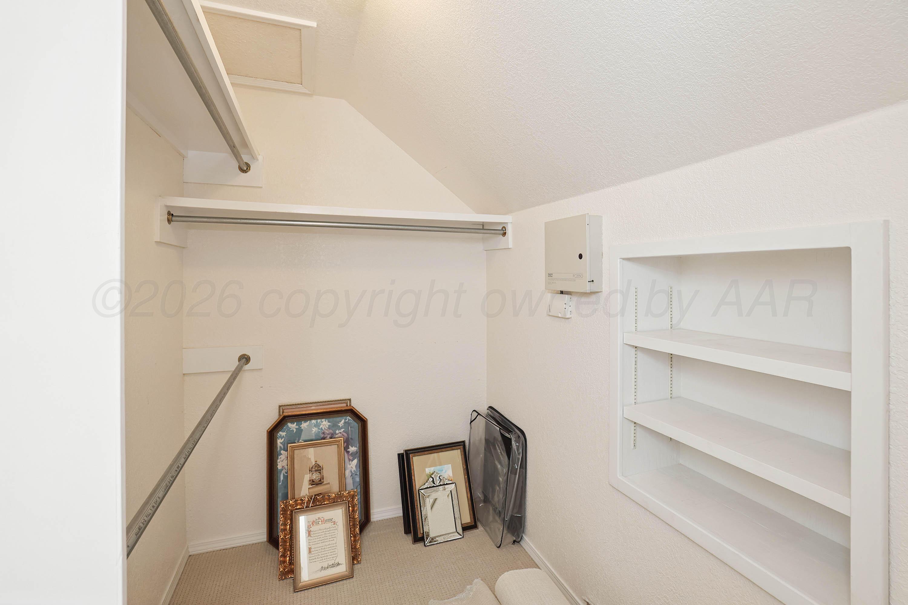 6904 Alpine Lane Amarillo, TX 79109 - Photo 31 of 45 a view of walk in closet with empty racks