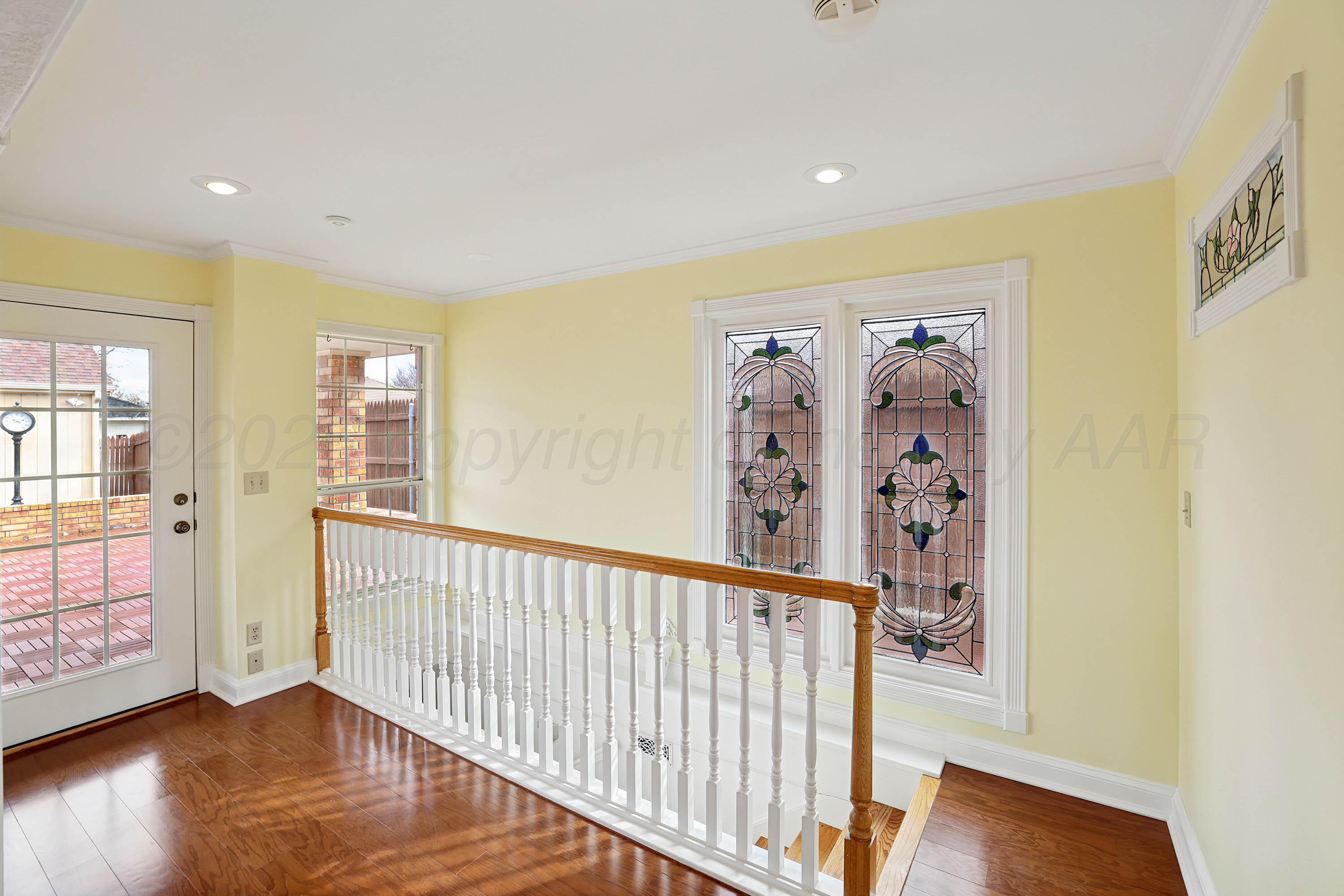 6904 Alpine Lane Amarillo, TX 79109 - Photo 33 of 45 a view of a hallway with wooden floor and windows