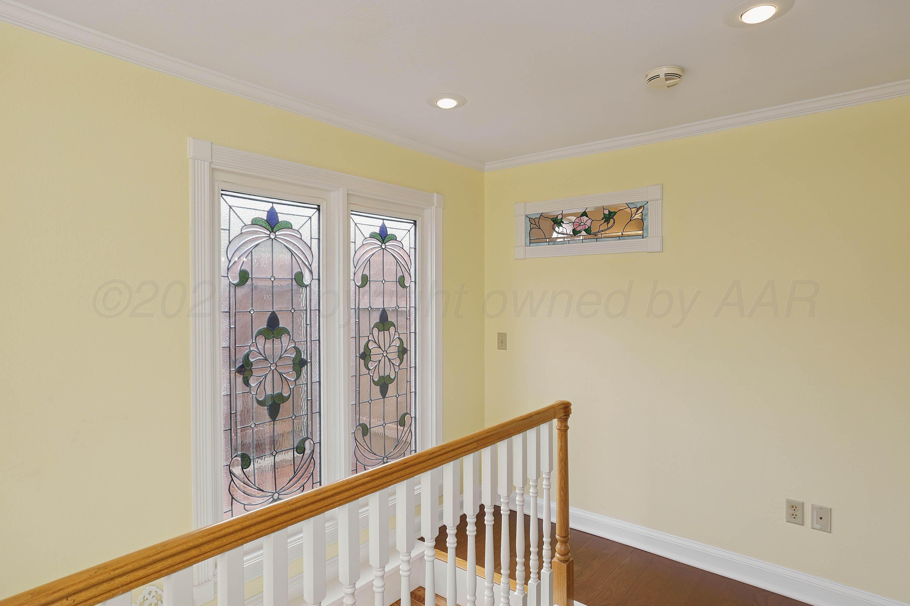 6904 Alpine Lane Amarillo, TX 79109 - Photo 34 of 45 a view of a hallway with a wooden floor