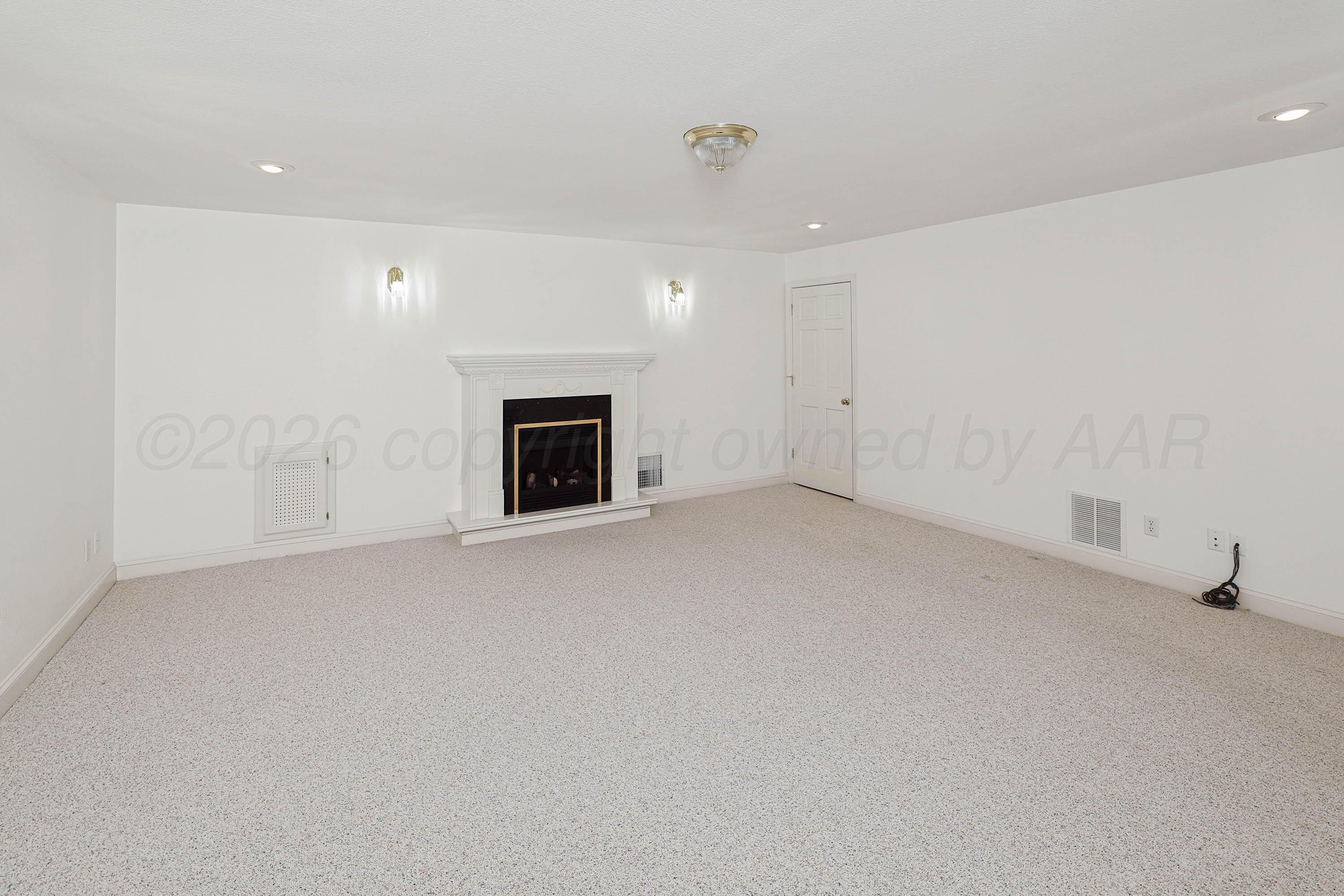 6904 Alpine Lane Amarillo, TX 79109 - Photo 35 of 45 a view of empty room with a fireplace